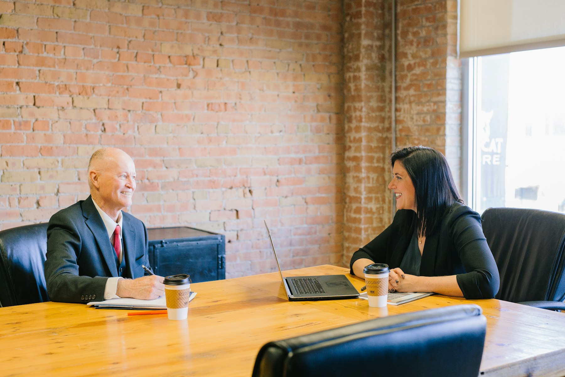 Consultant smiling at a laptop in a warm office