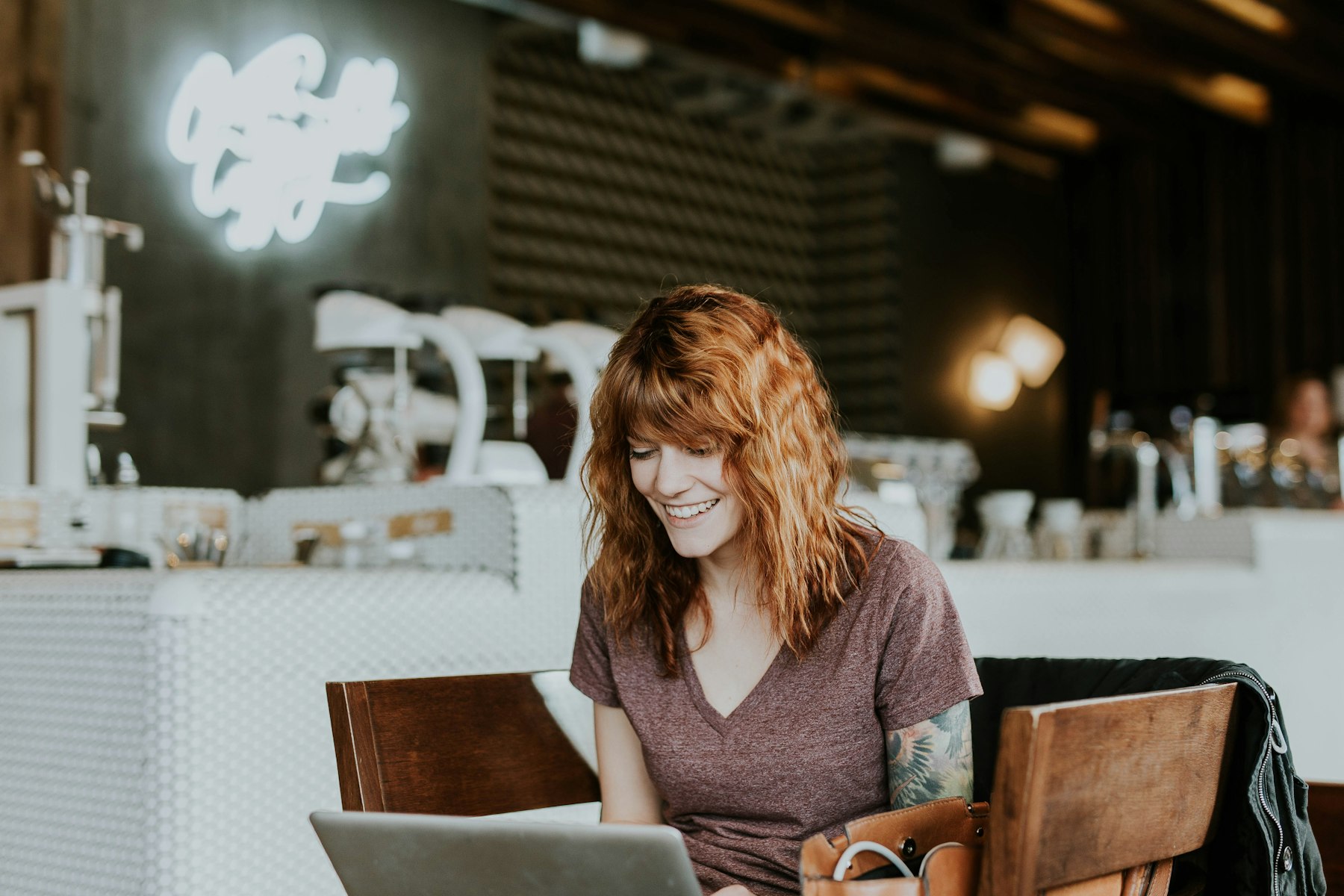 Owner working on a laptop in her cafe