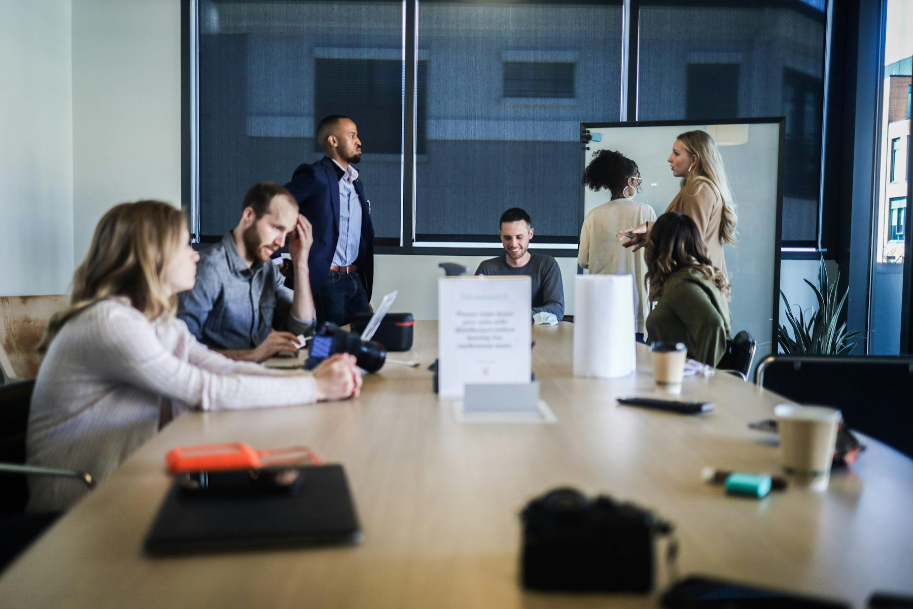 Two colleagues working through a plan at a whiteboard